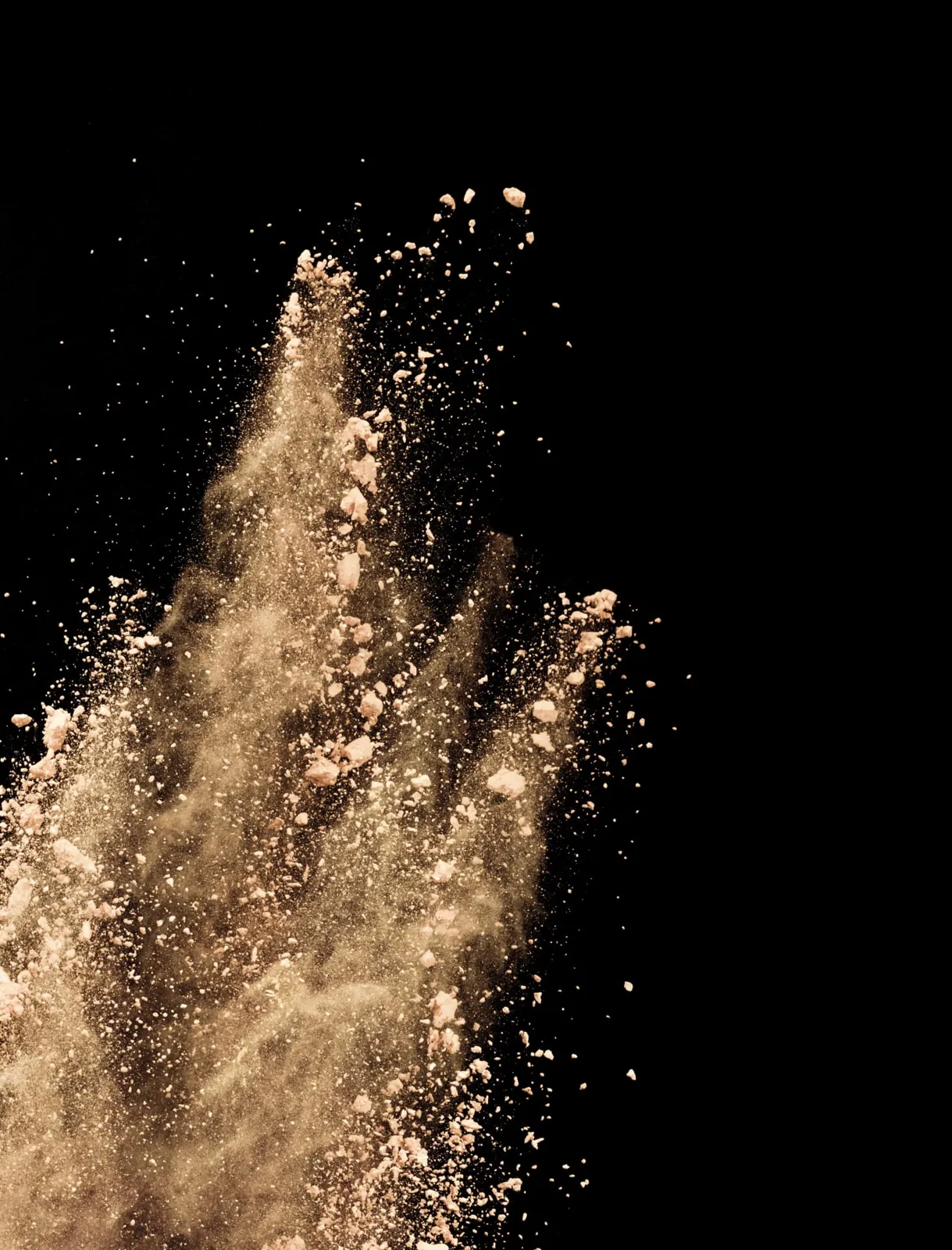 Mushroom powder captured mid-air against a dark background
